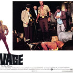 Long Tom (Paul Gleason), Ham (Darrell Zwerling), Doc (Ron Ely), Monk (Michael Miller) and Johnny (Eldon Quinn) look over the body of a dead Mayan assassin in Doc Savage: The Man of Bronze.