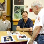 Pulpcon guest of honor Ernest Chiriacka, left, and David Saunders, son of pulp artist Norman Saunders, talk with Al Tonik on Friday.