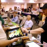 Ron Hanna, left, of Wild Cat Books, talks with a customer about the second edition of Jay Ryan’s The Handbook of Bronze.