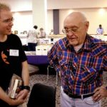 Chris Kalb, left, talks with Wooda “Nick” Carr on Saturday. Chris purchased an issue of The Spider at the Friday night auction that contained a letter from “Pvt. Nick Carr.”