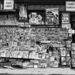 Publications are almost falling off this overly loaded magazine rack (date and location unknown). Publications are almost falling off this overly loaded magazine rack (date and location unknown).